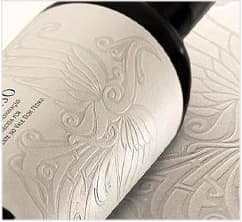 Premium label with intricate blind embossed pattern on textured cream paper